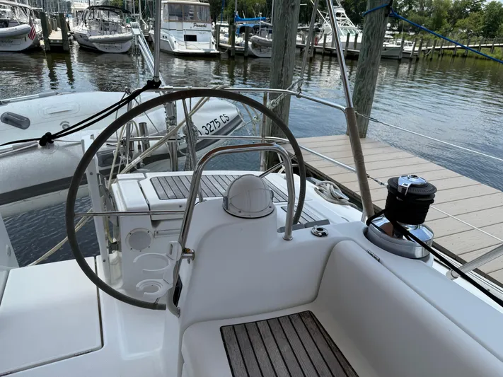 Passion Place Yacht Photos Pics Cockpit view of a 2007 Beneteau 49 sailboat docked at a marina.
