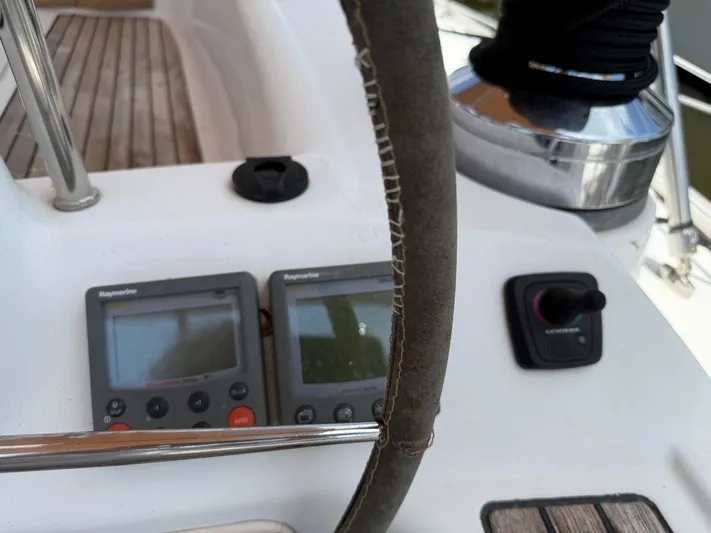 Passion Place Yacht Photos Pics Steering wheel and navigation instruments on a 2007 Beneteau 49 sailboat.