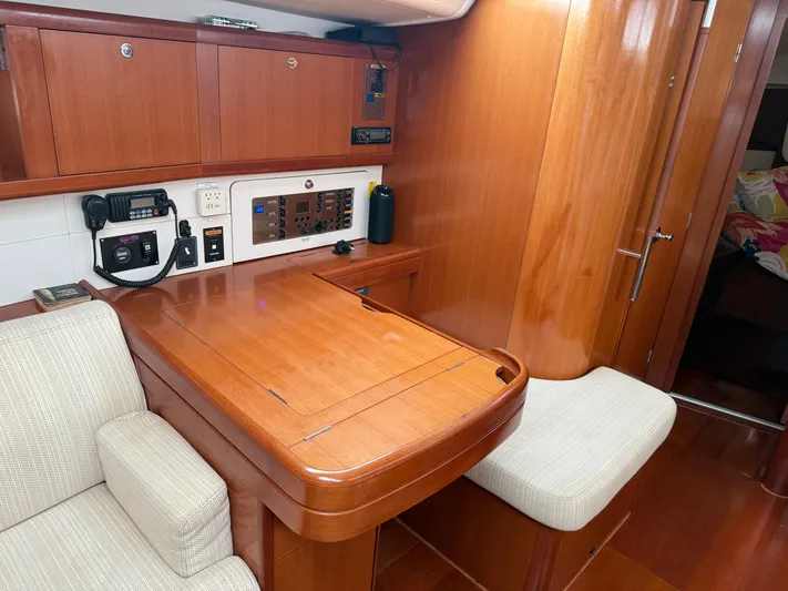 Passion Place Yacht Photos Pics Interior of 2007 Beneteau 49 yacht with wooden cabinetry and navigation station.