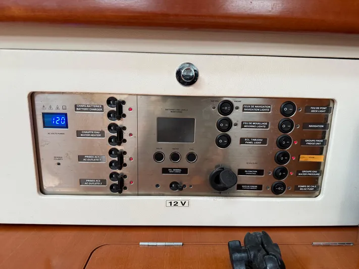 Passion Place Yacht Photos Pics Electrical control panel of a 2007 Beneteau 49 yacht, featuring various switches and indicators.