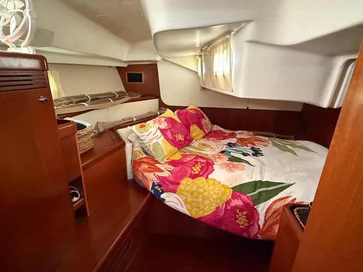 Passion Place Yacht Photos Pics Cozy cabin interior of 2007 Beneteau 49 yacht with floral bedding and wooden accents.