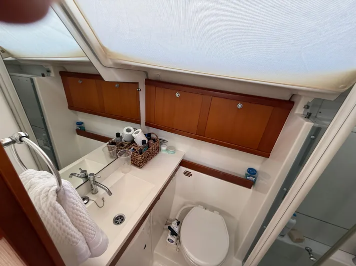 Passion Place Yacht Photos Pics Bathroom interior of a 2007 Beneteau 49 yacht with wooden cabinets and modern fixtures.