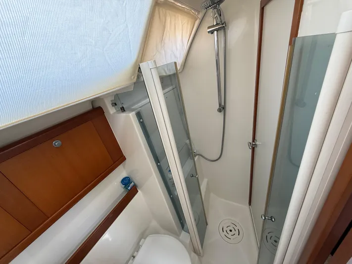 Passion Place Yacht Photos Pics Bathroom interior of 2007 Beneteau 49 yacht with shower and wooden cabinetry.