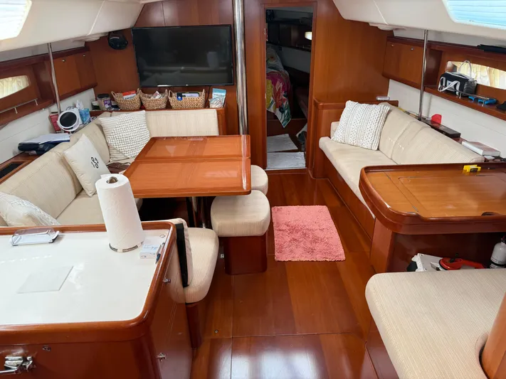 Passion Place Yacht Photos Pics Interior of a 2007 Beneteau 49 yacht with cozy seating and wooden finishes.