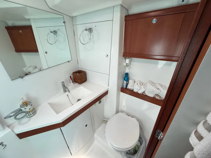 Passion Place Yacht Photos Pics Bathroom interior of 2007 Beneteau 49 yacht, featuring sink, mirror, and storage cabinets.