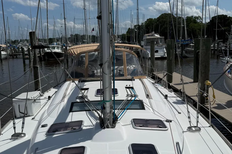 Passion Place Yacht Photos Pics Sailboat Beneteau 49, 2007 model, docked at marina with clear sky background.