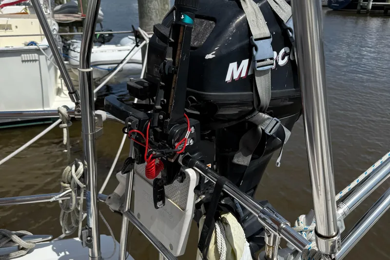 Passion Place Yacht Photos Pics Outboard motor mounted on a 2007 Beneteau 49 sailboat at a marina.