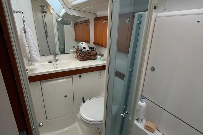 Passion Place Yacht Photos Pics Bathroom interior of a 2007 Beneteau 49 yacht, featuring a shower, sink, and toilet.