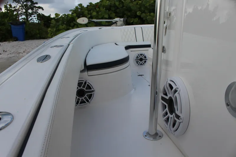  Yacht Photos Pics 2023 Contender 26 Bay boat interior with speakers and seating.