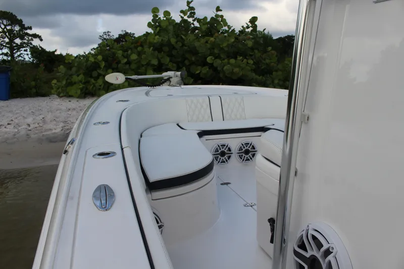  Yacht Photos Pics 2023 Contender 26 Bay boat interior with cushioned seating and speakers.