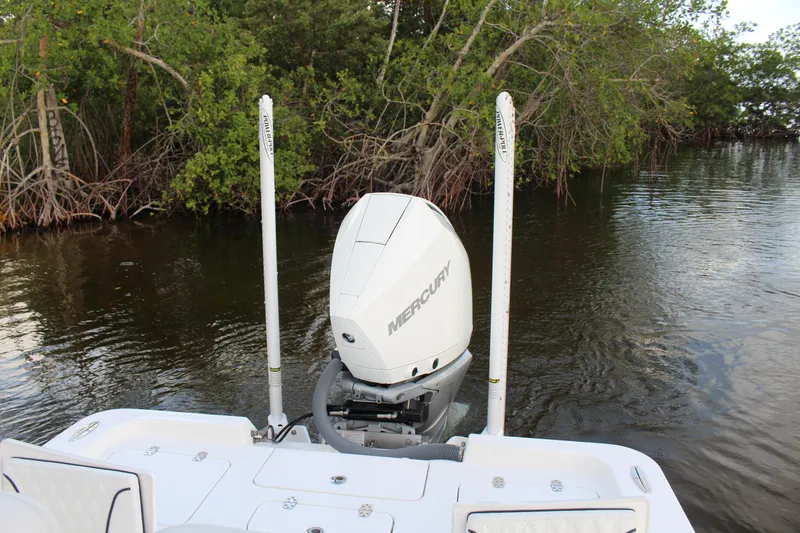  Yacht Photos Pics 2023 Contender 26 Bay boat with Mercury engine in a mangrove-lined waterway.