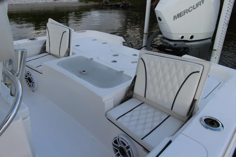  Yacht Photos Pics 2023 Contender 26 Bay boat interior with cushioned seating and Mercury engine.