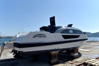2023 Custom Limo Tender boat on dock with ocean background.