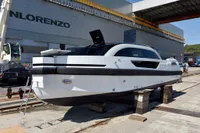 2023 Custom Limo Tender yacht in shipyard, sleek design, white and black exterior.
