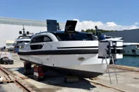 Custom 2023 Limo Tender yacht on dock, sleek design, modern features, luxury maritime vessel.