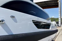 2023 Custom Limo Tender boat, sleek design, docked outdoors under clear sky.