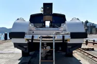 2023 Custom Limo Tender yacht on dock, rear view with ladder and propeller.