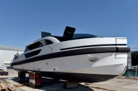 2023 Custom Limo Tender yacht on dry dock under clear blue sky.