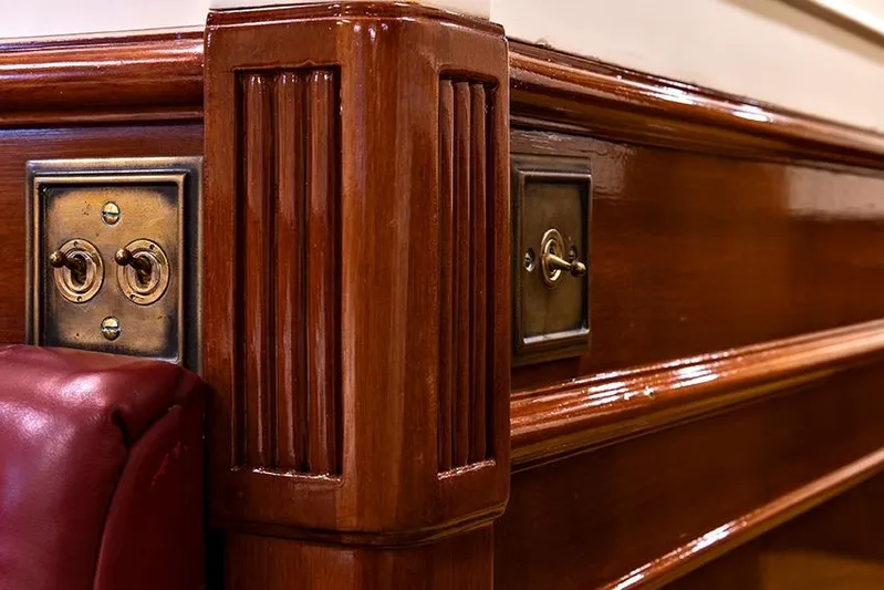 Invader Yacht Photos Pics Polished wooden interior with vintage brass switches on 1905 Gaff Schooner by G. LAWLEY & Son.