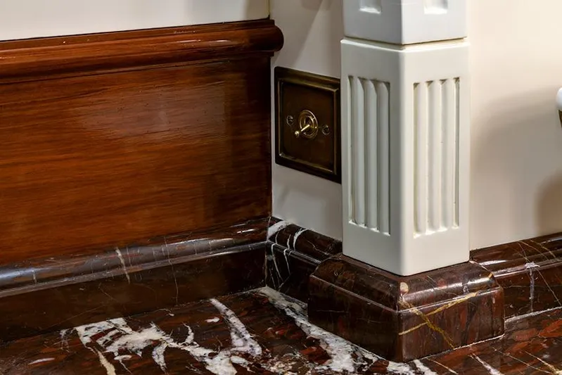 Invader Yacht Photos Pics Luxurious interior detail with wood paneling and marble flooring on a 1905 Gaff Schooner.