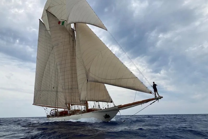 Invader Yacht Photos Pics Historic 1905 Gaff Schooner sailing on open sea under cloudy skies.
