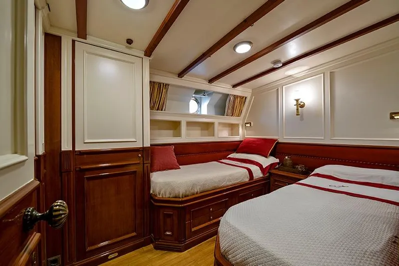 Invader Yacht Photos Pics Luxurious 1905 Gaff Schooner cabin with elegant wood paneling and twin beds.
