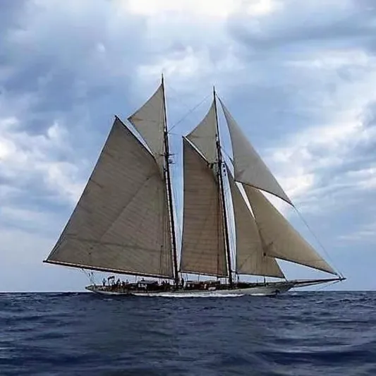 Invader Yacht Photos Pics Historic 1905 Gaff Schooner by G. LAWLEY & Son, sailing under cloudy skies.