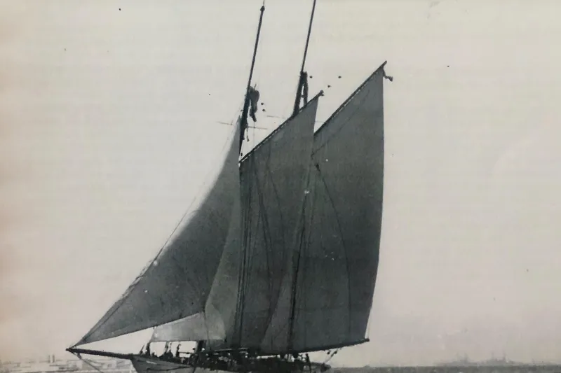 Invader Yacht Photos Pics Vintage 1905 Gaff Schooner by G. LAWLEY & Son Corporation sailing on open water.
