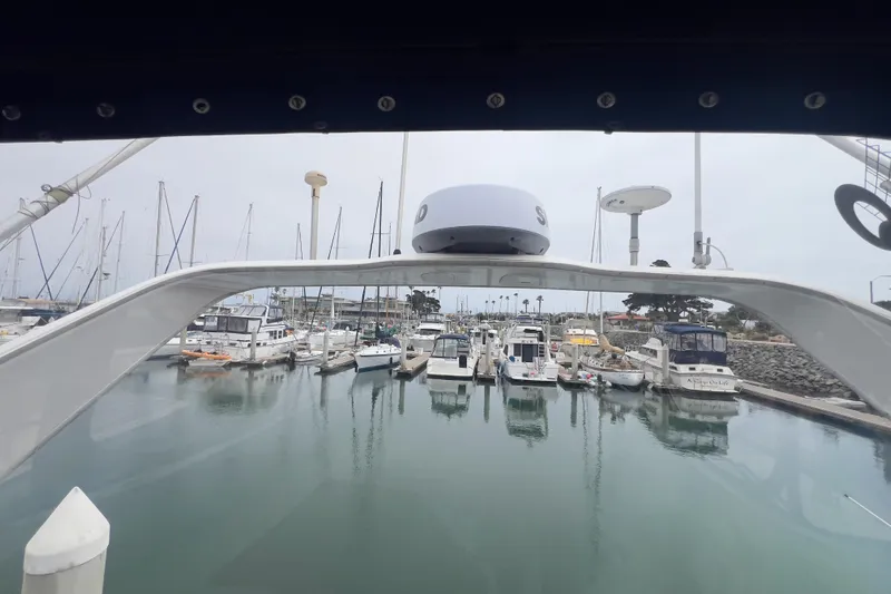  Yacht Photos Pics 1999 Bayliner 3988 Command Bridge Motoryacht docked in a marina with other boats.