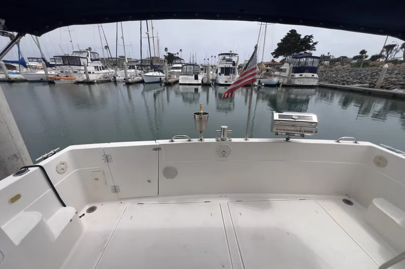  Yacht Photos Pics 1999 Bayliner 3988 Command Bridge Motoryacht docked in a marina, rear view.