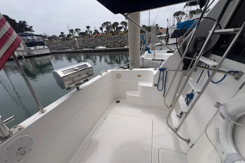  Yacht Photos Pics 1999 Bayliner 3988 Command Bridge Motoryacht docked, featuring outdoor seating and grill.