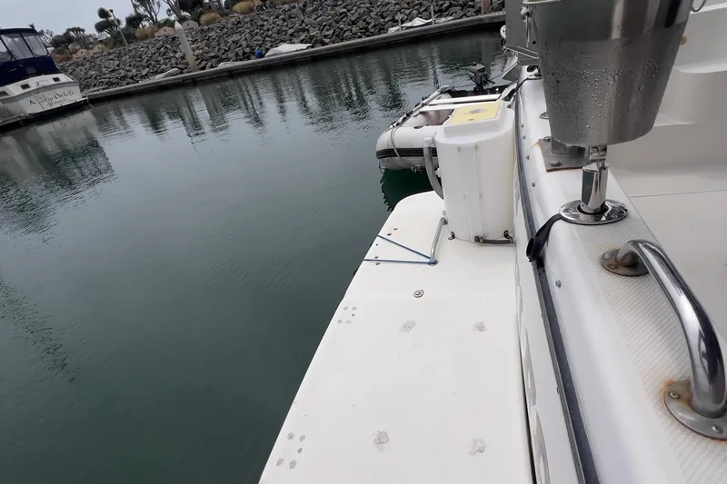  Yacht Photos Pics 1999 Bayliner 3988 Command Bridge Motoryacht docked in a calm marina.