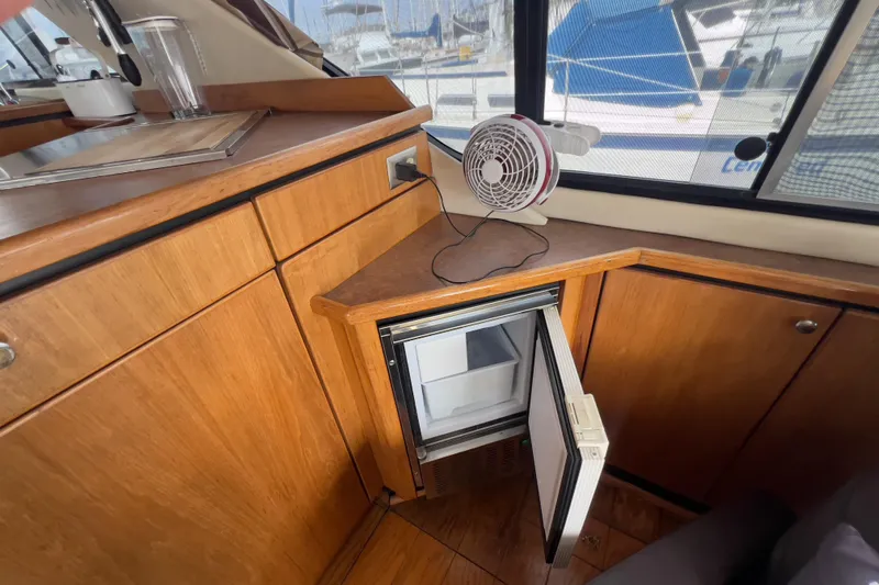  Yacht Photos Pics 1999 Bayliner 3988 Command Bridge Motoryacht interior with mini fridge and fan.