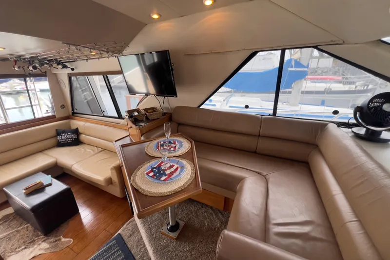  Yacht Photos Pics Luxurious interior of 1999 Bayliner 3988 Command Bridge Motoryacht with leather seating and dining area.