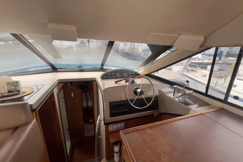  Yacht Photos Pics 1999 Bayliner 3988 Command Bridge Motoryacht helm with steering wheel and control panel.
