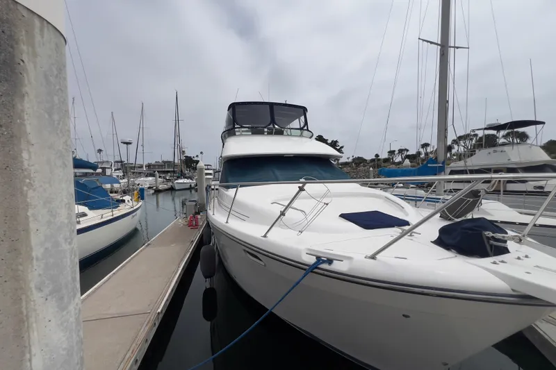  Yacht Photos Pics 1999 Bayliner 3988 Command Bridge Motoryacht docked at marina, surrounded by sailboats.