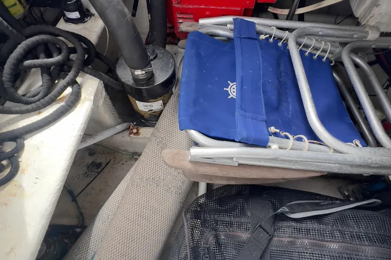  Yacht Photos Pics 1999 Bayliner 3988 Command Bridge Motoryacht interior with blue folding chair and equipment.