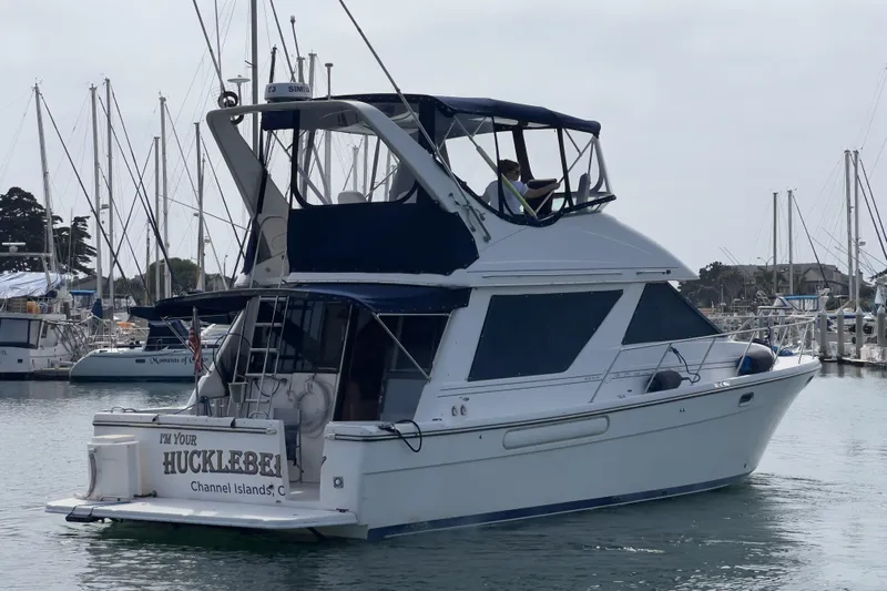  Yacht Photos Pics 1999 Bayliner 3988 Command Bridge Motoryacht docked in a marina, Channel Islands.