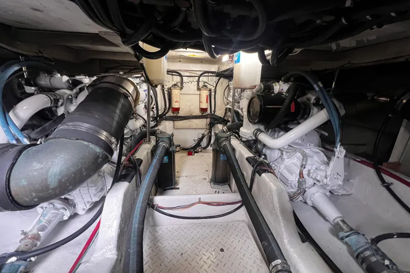  Yacht Photos Pics Engine room of a 1999 Bayliner 3988 Command Bridge Motoryacht, showcasing mechanical components.