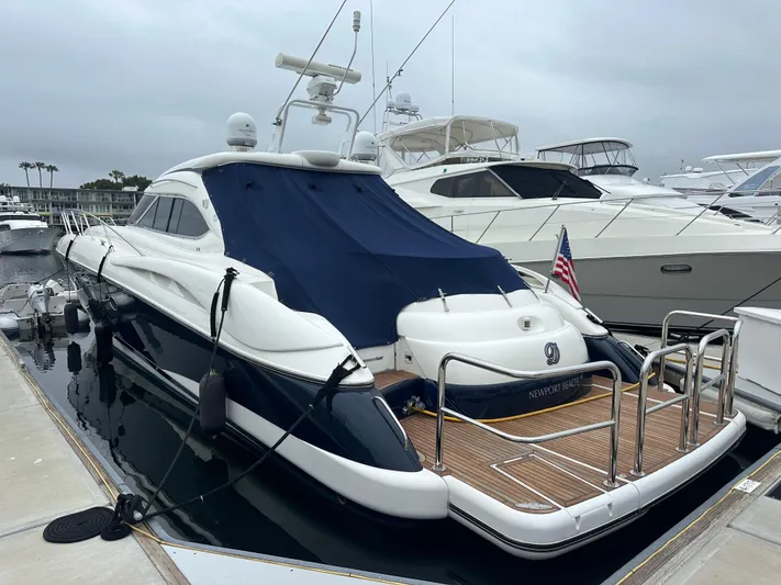  Yacht Photos Pics Sunseeker Predator 60 yacht, 2000 model, docked at marina with blue cover.