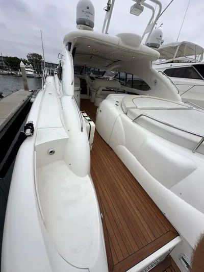  Yacht Photos Pics Sunseeker Predator 60 yacht, 2000 model, featuring sleek white design and wooden deck.