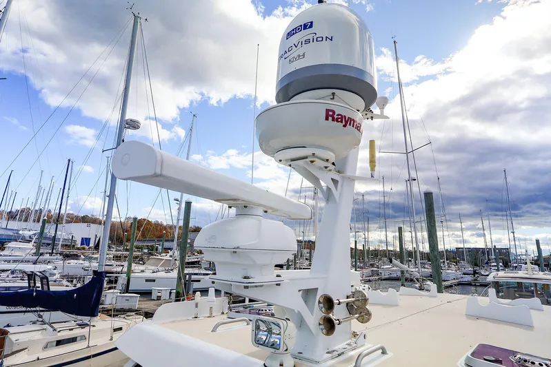  Yacht Photos Pics 2005 New England Boatworks Downeast Sedan with advanced radar equipment in a marina.