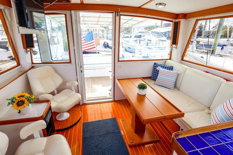  Yacht Photos Pics Interior of 2005 New England Boatworks Downeast Sedan with seating and decor.