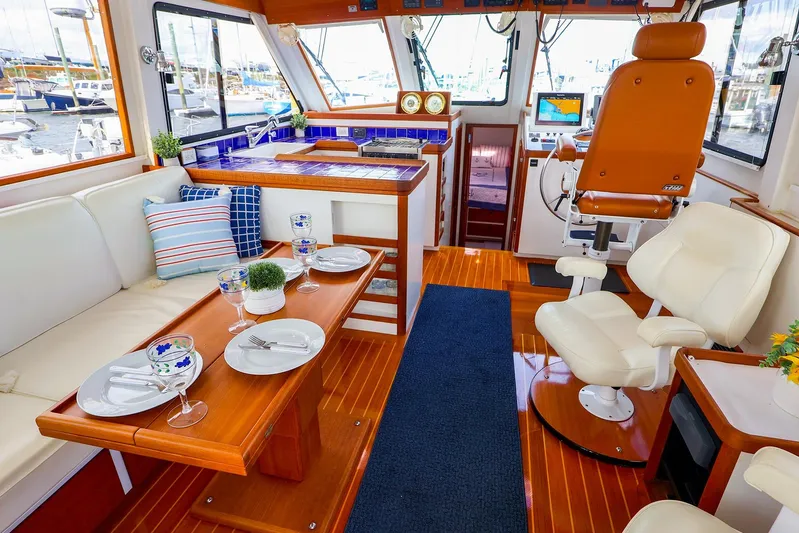  Yacht Photos Pics Luxurious 2005 New England Boatworks Downeast Sedan interior with elegant seating and dining area.