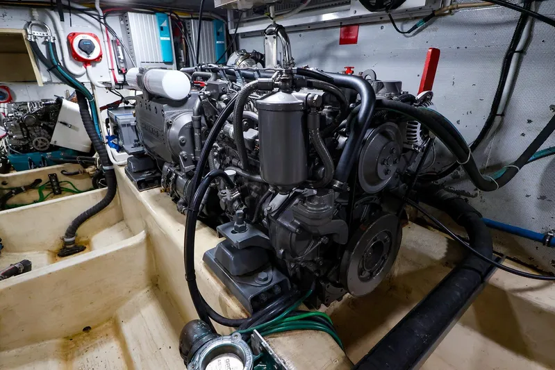  Yacht Photos Pics Engine room of 2005 New England Boatworks Downeast Sedan, showcasing detailed mechanical components.
