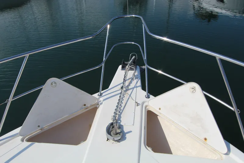  Yacht Photos Pics Bow view of 2005 Riviera 46 Convertible Sportfisher with anchor chain and railing.