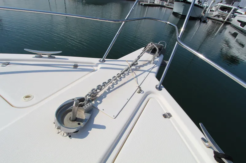 Yacht Photos Pics Bow of 2005 Riviera 46 Convertible Sportfisher with anchor chain and railing.
