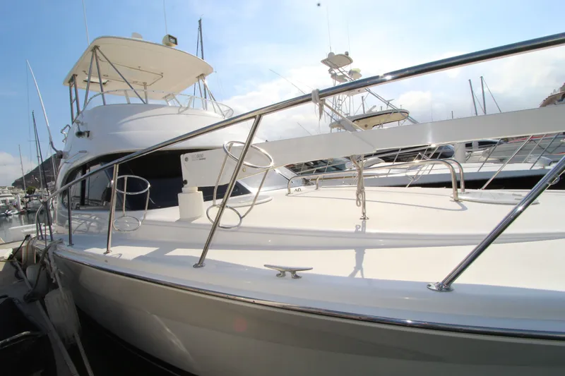  Yacht Photos Pics 2005 Riviera 46 Convertible Sportfisher yacht docked at marina under clear sky.