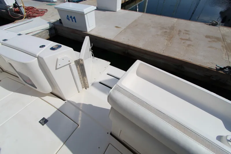  Yacht Photos Pics 2005 Riviera 46 Convertible Sportfisher boat deck near dock, showing storage compartments.