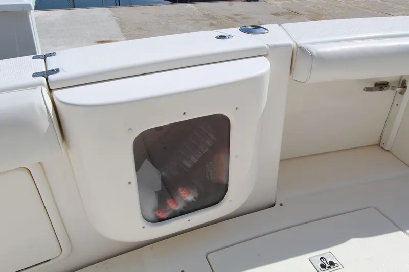  Yacht Photos Pics 2005 Riviera 46 Convertible Sportfisher boat storage compartment with visible beverages inside.